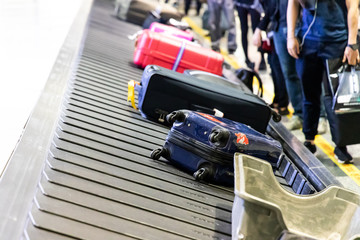 Fototapeta premium Baggage luggage on conveyor carousel belt at airport arrival