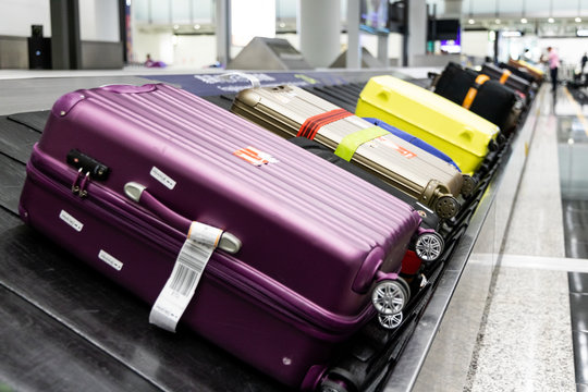 Baggage Luggage On Conveyor Carousel Belt At Airport Arrival