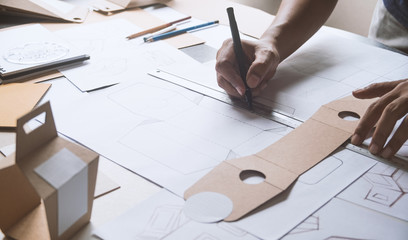 Designer sketching drawing design Brown craft cardboard paper product eco packaging mockup box...