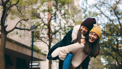 Two asian women having fun outdoors