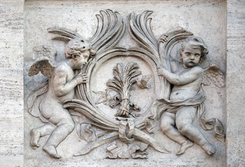 Angels with symbols of martyrdom on the portal of Sant Andrea della Valle Church in Rome, Italy 