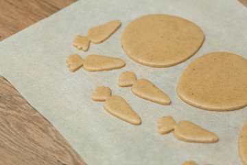 close up of female hands making cookies from fresh dough at home