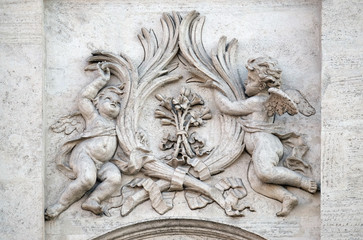 Angels with symbols of martyrdom on the portal of Sant Andrea della Valle Church in Rome, Italy