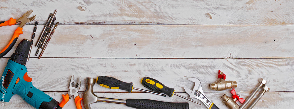 Wall mural top view of set of hand tools on wooden background with copy space, suitable for header or banner