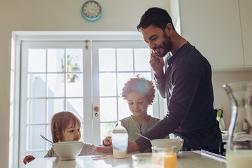 Father with his kids at the breakfast table
