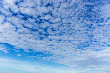 blue sky background with tiny clouds