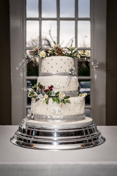 Wedding Cake With Floral Decoration And Silver Cake Stand