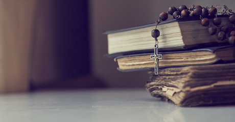 The rosary beads on Catholic Church liturgy books. - 247186197