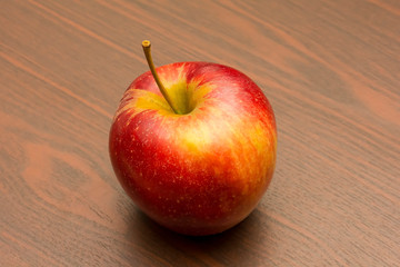 red apple on wooden table