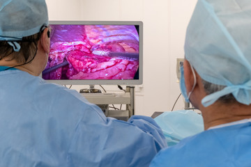 Broadcasting the work of two surgeons' doctors. Copy space. Endoscopy. Video image of the internal organs of the patient on the TV screen or high resolution monitor. Laparoscopy in the hospital.