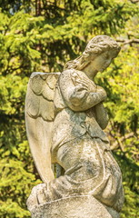 Fototapeta na wymiar Ancient stone statue of the praying angel