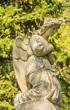 Ancient stone statue of the praying angel
