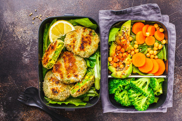 Healthy meal prep containers with green burgers, broccoli, chickpeas and salad.