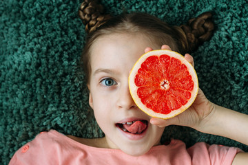 Portrait of a pretty young girl with exotic fruit. Healthy food. Focus on fruit.