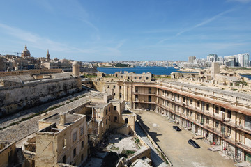 Dilapidated part of Fort St Elmo, Valletta with Sliema and Valletta in the background on a sunny day