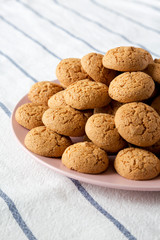 Homemade almond cookies on pink plate, side view. Close-up.
