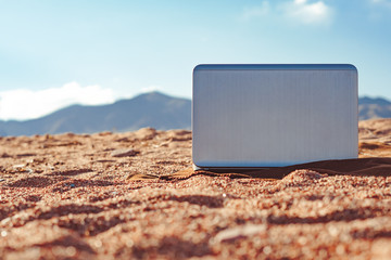 the laptop in the sand