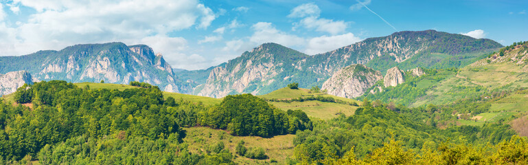 gorgeous panorama of countryside in springtime. beautiful landscape of romania. rural area on the near hills. distant ridge with rocks, cliffs and gorge. wonderful sunny forenoon