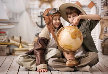 Boys in the form of traveler and the pilot playing in his room