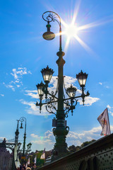 Bright sun over the lantern of Liberty Bridge Hungary