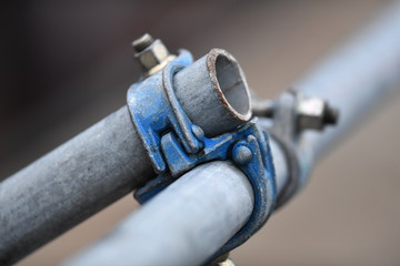 Partial view of a scaffolding. Two conected metal tubes.
