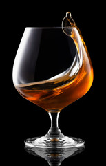 splash of brandy in snifter glass