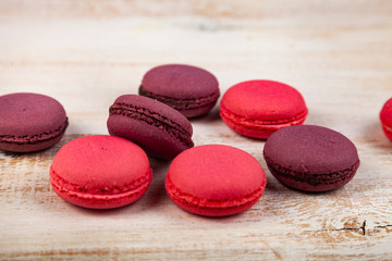 Berry macaroons on a wooden background
