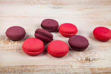 Berry macaroons on a wooden background
