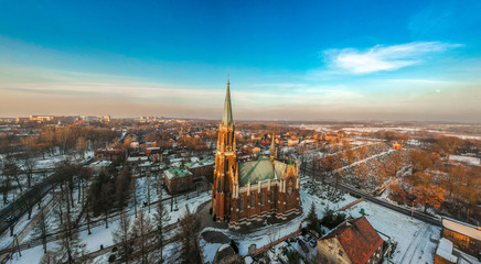 Aerial view of the Catholic Church, Poland during sunset with an empty city in the background.