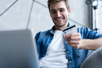 technology, shopping, banking, home and lifestyle concept - close up of man with laptop computer and credit card at home.