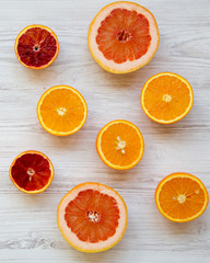 Citrus fruits (orange, grapefruit, sicilian orange) on white wooden background, from above. Flat lay. Top view, overhead.