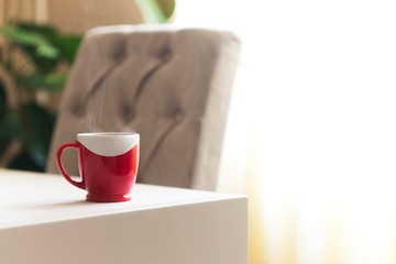 red cup of coffee on table. hot black coffee isolated