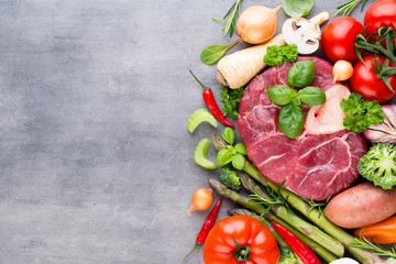 Raw fresh meat Ribeye Steak with vegetables and spice.