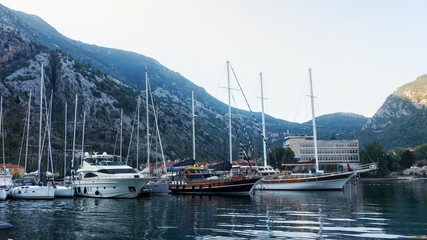 Fototapeta na wymiar Yachts and boats in the bay on the background of mountains