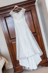Fototapeta na wymiar Wedding dress hanging up before the ceremony