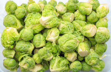 Brussels sprouts in a disposable container on a white background. View from above. The concept of healthy eating, diet. Background Texture