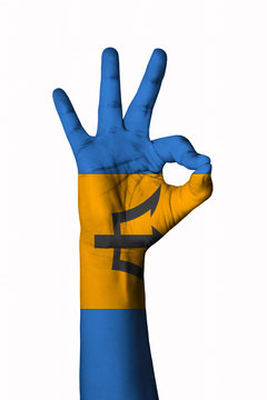 Hand making Ok sign, Barbados flag painted as symbol of best quality, positivity and success - isolated on white background