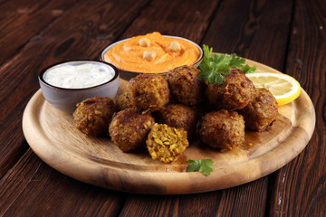 Traditional homemade hummus, falafel and chickpea served with spices on table. Jewish Cuisine.