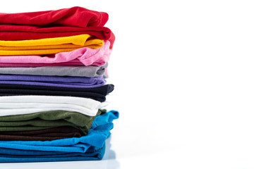 Stack of Colorful cotton T-shirt isolated on white background.