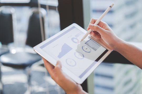close up on businesswoman manager hand using stylus pen for writing or comment on screen dashboard tablet in meeting situation about company's performance , technology and business strategy concept	
