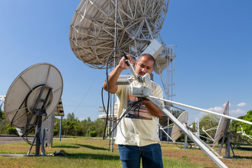 man manipulating antenna electronics