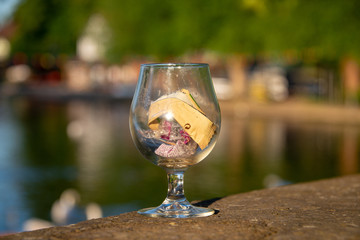 wine glass full of rubbish and waste food wrappers
