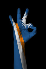 Hand making Ok sign, Marshall islands flag painted as symbol of best quality, positivity and...