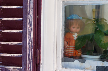 Puppets looking outside at an old window in Sibiu, Transilvanya 