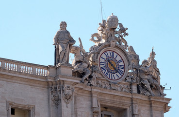 Fototapeta na wymiar One of the giant clocks on the St. Peter's facade. Two clocks were added in 1786-1790 by Giuseppe Valadier. Papal Basilica of St. Peter in Vatican, Rome, Italy