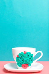 Mug, decorated with flowers made of polymer clay. Crafts from polymer clay. Mug decorated with stucco made of polymer clay