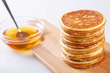 Fresh homemade delicious pancakes with syrup on white background