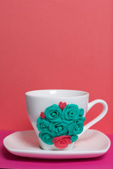 Mug, decorated with flowers made of polymer clay. Crafts from polymer clay. Mug decorated with stucco made of polymer clay