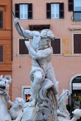 Piazza Navona, Neptune fighting with an octopus statue in the Fountain of Neptune in Rome, Italy