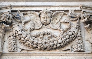 Angel, bass relief on the facade of Santa Maria in Via church in Rome, Italy  